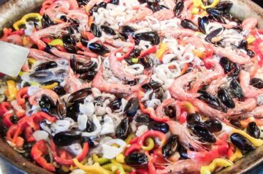 Preparing Fish Paella. Spanish Street Food in Milan, Italy