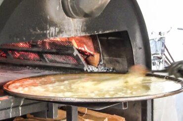 Cooking The Farinata Pancake of Chickpea Flour in a Flaming Oven. Italy Street Food