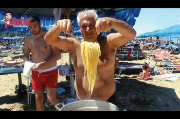 ITALIAN CHEF COOKING SEAFOOD PASTA ON THE BEACH
