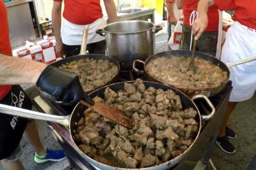Italy Street Food. Huge Pans Cooking Beef Stew and Corn 'Polenta'