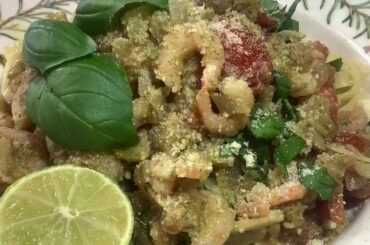 Real italian easy to cook Prawn pesto tagliatelle pasta dish with tomato and mushroom sauce