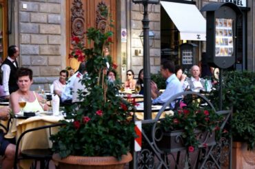 People eating outside a restaurant in Italy.