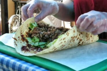 The Duck Meat Wrap with Caramel Onions. London Street Food. French Cuisine