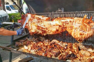 Whole Crispy Pork Roasted and Cut Austrian Style. Italy Street Food Fair