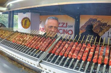Huge Automatic Machines Grilling Lots of Lamb Skewers. Italy Street Food