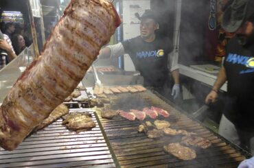 Huge Grill of Beef and Sausages from Argentina. Italy Street Food Festival