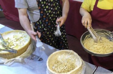 Spaghetti and Rice Hand Rolled in a Cheese Wheel. Italy Street Food
