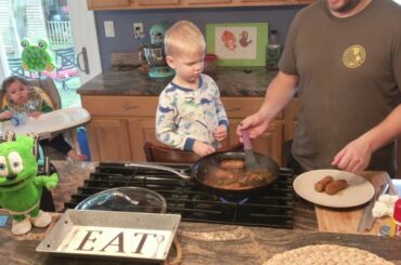 Dad and sons cook Italian sausage