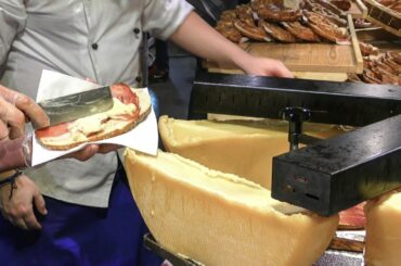 Italy Street Food. Cascades of Melted Cheese on Huge Pretzel and Sandwiches