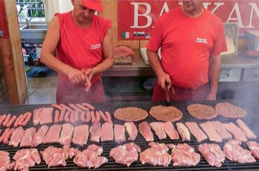 Best of Balkans Street Food. Mixed Meat Roasted on Huge Grills. Street Food Festival seen  in Italy