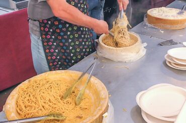 Huge Parmesan Cheese Wheels Cooked Italian Pasta and Rice. Italy Street Food