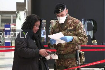 Italy: Military and police officers inspect Milan train passengers amid coronavirus lockdown