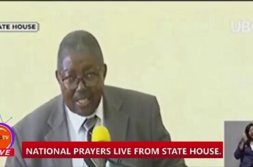 A PREACHER READS A LETTER FROM A FRIEND WHO LIVES IN MILAN ITALY TO UGANDANS.