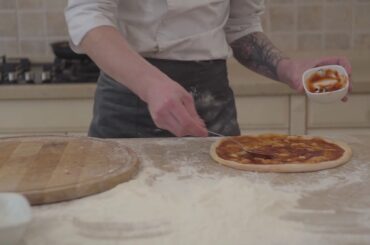 Pizza maker cooking on traditional italian recipe chef making with tomato pasta in pizzeria process