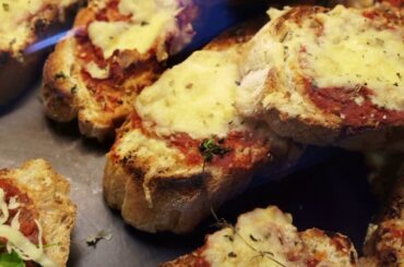 italian style cheese over tomatoes pizza sauce on bread slice