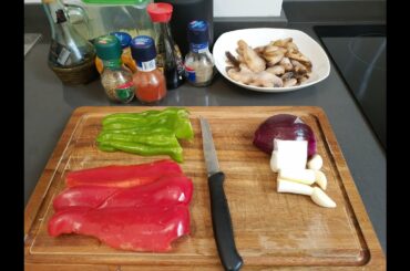 Italian man cooks stir-fry chicken, mushroom and bell pepper (Chinese style)