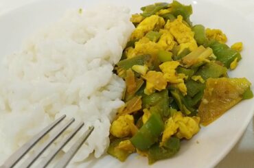 Italian man cooks Chinese stir-fry friggitelli green peppers and eggs