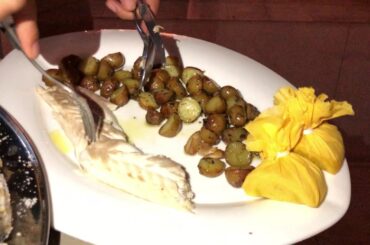 Authentic Italian Fine Dining experience with prepare fish in front of guests table.