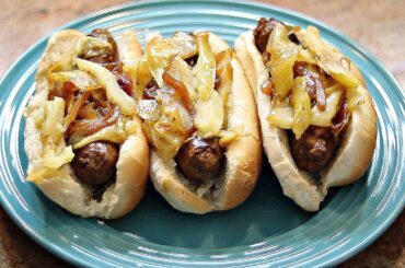 Italian Sausage Topped with Cabbage, Onion and Apples on a Bun
