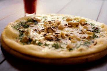 appetizing pizza with mushrooms fragrant herbs melted cheese italian pizza on the wooden