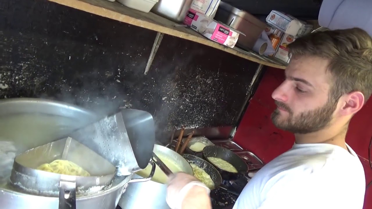 Italian Street Food Hand Rolled Pasta Fettuccine Alfredo by Cheese Wheel, Camden Lock Market Londo Italian Street Food Hand Rolled Pasta Fettuccine Alfredo by Cheese Wheel, Camden Lock Market Londo