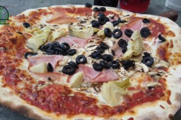 Italian Food Video of Pizza with Ham Olives mashrooms by Donna Mia Restaurant in Trier on asparagus