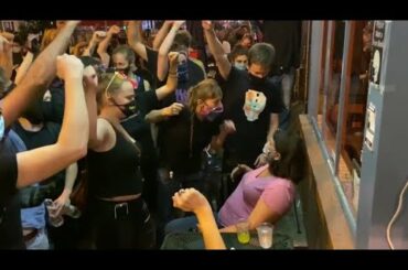 Mob order lone woman to "put your fist up" outside restaurant in Columbia Heights