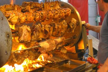 International Street Food Event in Italy. Huge Rotisserie, Grills of Meat, Seafood. Street Food