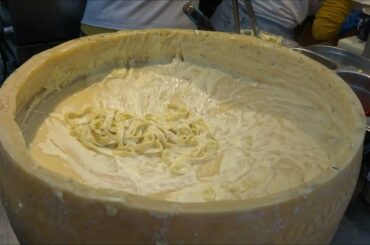 Italian pasta in a parmesan cheese wheel - Italian Street Food