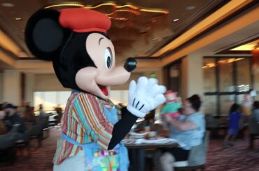 Mickey and Friends dancing during the character breakfast at Topolino's Terrace