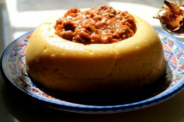 Polenta cooked in a pressure cooker, with porcini mushroom and sausage ragout