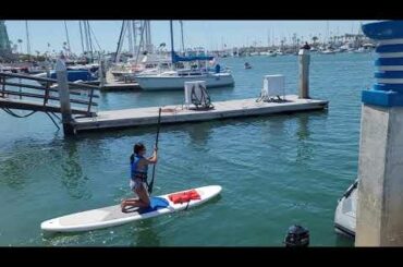 Stand up paddle boarding at the Grand Canal in Balboa Island Newport Beach California USA