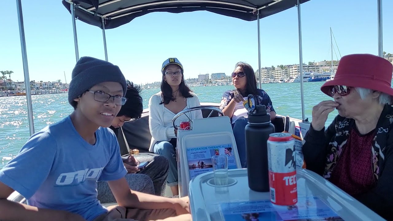 Beautiful hot summer day boat cruising at the Grand Canal in Balboa Island Newport Beach CA Beautiful hot summer day boat cruising at the Grand Canal in Balboa Island Newport Beach CA