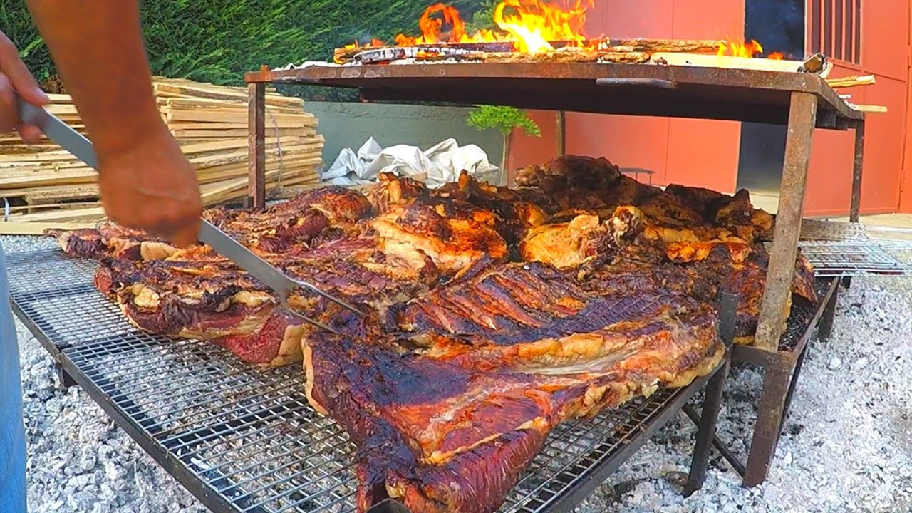 Italian Street Food Festival of Bull Meat. Huge Blocks of Meat on Grill Italian Street Food Festival of Bull Meat. Huge Blocks of Meat on Grill