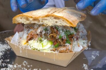 Sandwich of Pulled Pork Meat, Parmigiano Reggiano Italian Cheese and Sauces. London Street Food