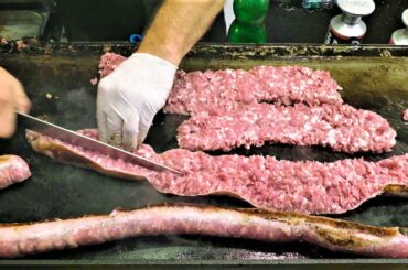 Sicily Street Food, Italy. Busy Grill with Huge Sausages and Traditional 'Stigghiola' and 'Meusa'
