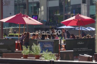 People Dining Outdoors At Salvi's Italian Restaurant In Exchange Square, Manchester, UK