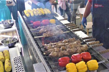 Street Food in Kyiv, Ukraine. Grilled Meat, Fried Fish, Sausages, Noodles, Cheese and more Food