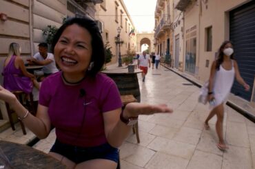 Wine and people watching on a street in Marsala Sicily Italy