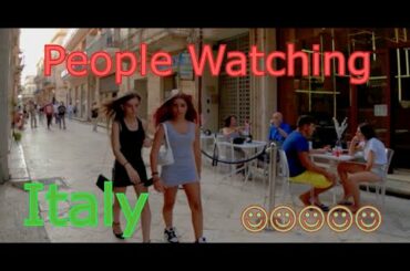 Rose and Will drink a glass of wine at a street bar in Italy