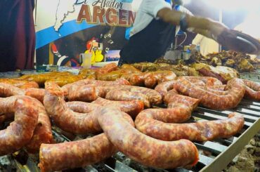 Argentina Street Food. Huge Grills of Asado, Sausages, Ribs and Meat. Street Food Festival in Italy