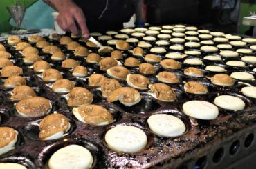Italy Street Food. Cooking Small Pancakes with Nutella. Traditional Poffertjes from Holland