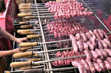 Street Food of Italy. Huge Skewers on Grill. Sausages, Ribs, Pork Meat filled with Melted Cheese