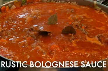 The best Italian meat sauce ever!  Nanny cooks Rustic Bolognese Sauce over pasta. Thick and hearty.
