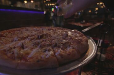 Seasoning Pizza at Italian Restaurant