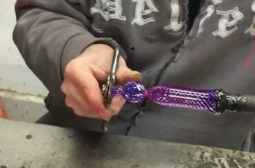 Glass Artisan in Murano, Italy making a glass bead