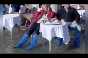 Severe flooding doesn’t stop tourists from dining in the city of Venice, Italy