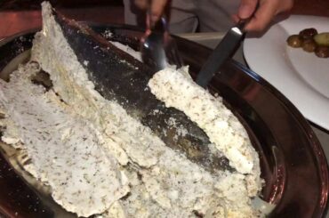 Authentic Italian Fine Dining experience with prepare fish in front of guests table.