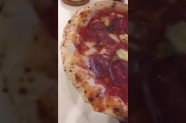 Cutting a fresh Italian stone baked pizza