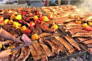 Street Food in Italy. Grilled Meat from Argentina, Asado, Sausages, Ribs, Pork Legs, Veal Steaks